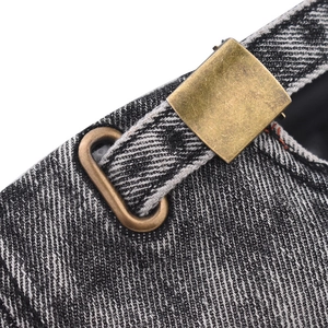 Detail of washed denim baseball cap with vintage bronze metal buckle and fine stitching