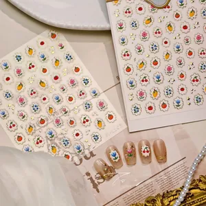 3D floral nail stickers with gold edges showing fruit patterns and tulip designs