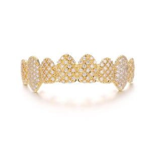 Detailed view of hip hop gold plated top teeth grillz with sparkling clear cubic zirconia