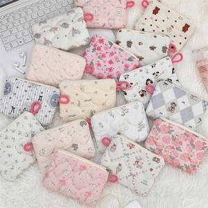 Detailed overhead view of quilted makeup bags with cute cartoon and floral patterns