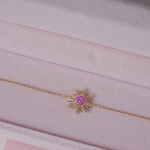 Macro shot of sun flower pendant necklace with pink opal and zircon in a jewelry box