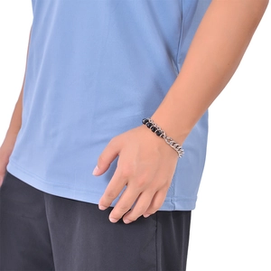 Detail of men's double-layer bracelet with black beads and silver Cuban chain link