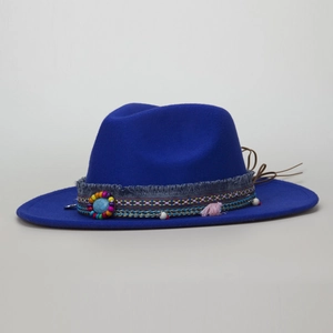 Close-up of ethnic band with beads and turquoise button on dark blue wool fedora