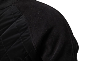 Detail of black quilted diamond pattern fabric and fleece raglan sleeve stitching