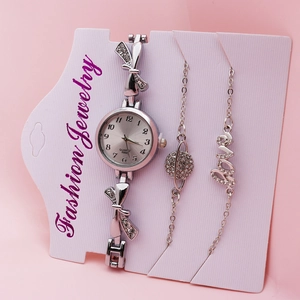 Detailed view of silver women's quartz watch set with bow-knot band and bracelets