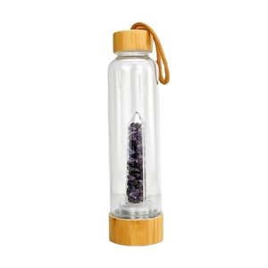 Bamboo lid glass water bottle with amethyst crystal infusion pillar on white background