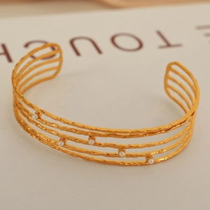 Minimalist C-shaped multi-layer open bangle in matte gold with delicate white pearls