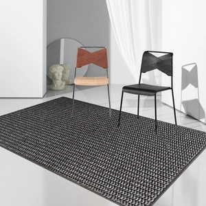 Macro detail of black and white woven texture carpet under modern minimalist chairs