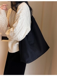 Minimalist black soft suede tote bag with large capacity shown on model shoulder