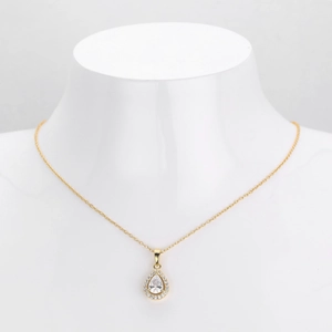 Detailed view of gold pear-shaped double-layer pendant necklace with sparkling zircons
