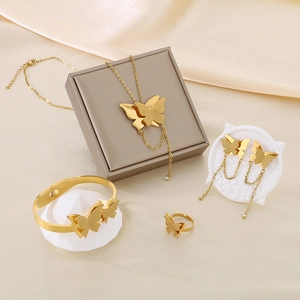 Detail shot of golden stainless steel butterfly jewelry set with necklace and bracelet