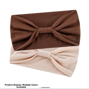 Detail of dark brown and beige knotted headbands with high-elastic ribbed knit texture