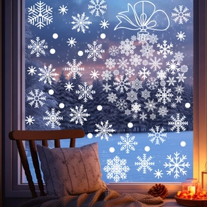 Close-up of white snowflake window clings with a festive bow hanging ball design