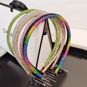 Close-up of sparkling rhinestone headbands in green, champagne, and gradient colors