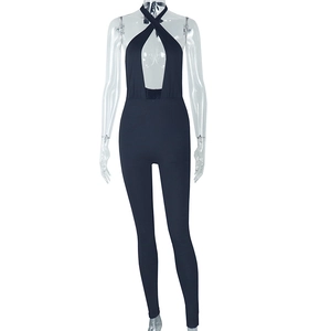Detail of black halter neck jumpsuit featuring a cutout design and slim fit silhouette