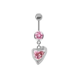 Detail of silver belly ring featuring a pink heart-shaped zircon and polished metal finish