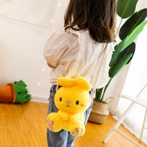 Cute yellow plush bunny crossbody bag for kids with adjustable strap shown on model