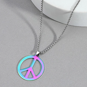 Detailed close-up of rainbow gradient peace sign pendant on silver chain necklace