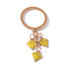 Golden keychain with yellow enamel diamond charms on a clean white background