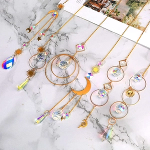 5-piece set of AB crystal suncatchers with gold sun, moon, and star charms for garden windows