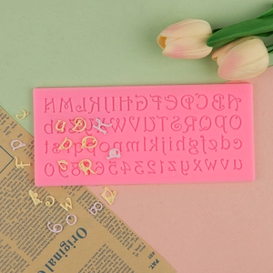 Macro detail of pink silicone mold with full A-Z letters and 0-9 numbers for cake decor