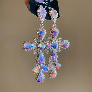 Detail of colorful crystal cross drop earrings with sparkling rhinestone settings