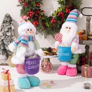Detail of Christmas snowman and gnome plush dolls with Merry Christmas embroidery