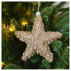 Close-up of champagne gold sequined star ornament with pearl hanging on Christmas tree