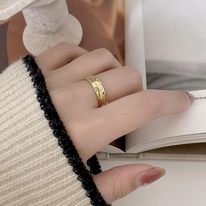 Macro shot of irregular textured gold-plated ring showing handmade hammered details