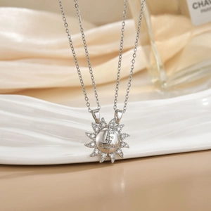 Macro detail of sun puzzle necklaces with You Are My Sunshine engraving and zircon inlay
