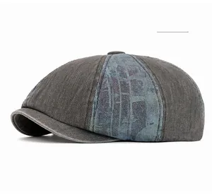 Detail of grey washed denim newsboy cap with blue plaid patchwork and top button