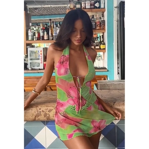 Detail of green halter dress with pink floral print and sexy backless design