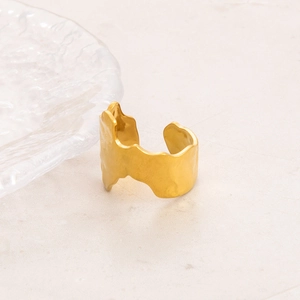 Detail of wide 18K gold plated stainless steel ring with irregular hammered wavy texture