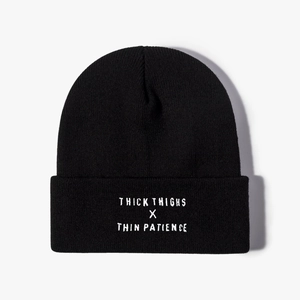 Black knit beanie featuring Thick Thighs x Thin Patience white embroidery on the cuff