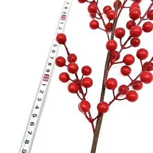 Artificial red berry branch decor with 40cm height shown next to measuring tape
