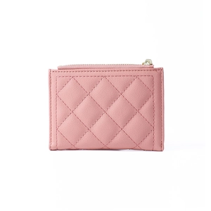 Detail of pink quilted PU leather wallet with zipper closure and lychee texture