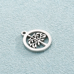 Macro shot of silver stainless steel round tree of life hollow charm with top ring
