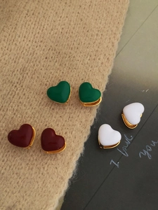 Three pairs of heart-shaped gold-plated enamel earrings in green, burgundy, and white