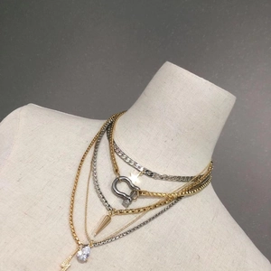 Hip hop layered necklace with gold and silver chains, rhinestone heart and bolt pendants