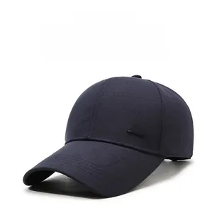 Detailed close-up of navy cotton baseball cap with silver metal style lettering logo