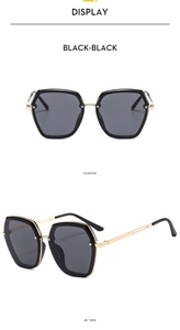 Detail view showing front and 45-degree angles of black and gold hexagonal sunglasses