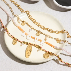 Three-piece beach style necklace set with LOVE beads, shells, and palm tree surf pendants