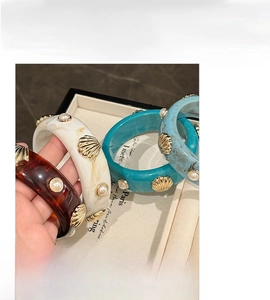 Detail view of resin shell pearl bangle with an inner diameter of about 6.5cm