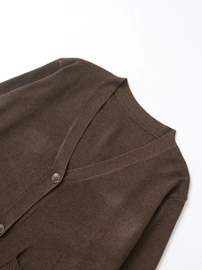 Detail of dark brown knit cardigan showing V-neck design and matching buttons