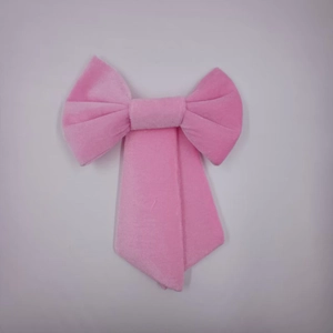Detailed macro view of a large pink velvet bow showing soft texture for wedding party decor