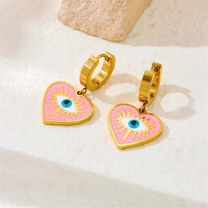 Pink heart evil eye earrings with gold plating and enamel charms in a studio shot