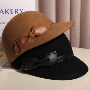 Detail of wool felt equestrian hats with leather bows and metallic stud decorations