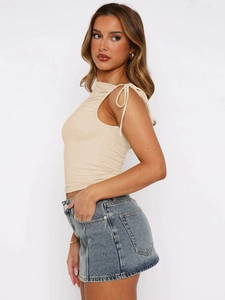 Detailed side view of beige sleeveless crop top with side drawstring and ruched design