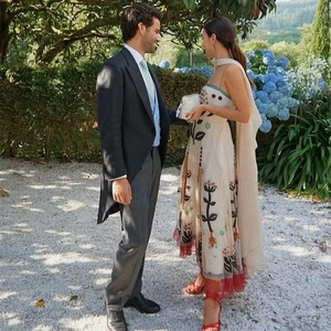 Bohemian floral printed maxi dress with mesh stitching and matching scarf in a garden setting
