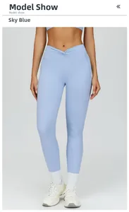 Detail of high waisted sky blue yoga pants with a V-shaped crossover twisted waistband